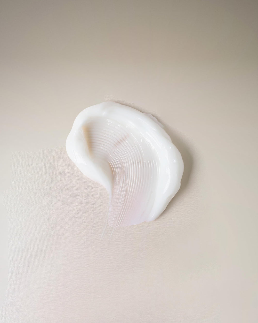 Close-up of Ouidad Curl Shaper cream dispense for quick styling