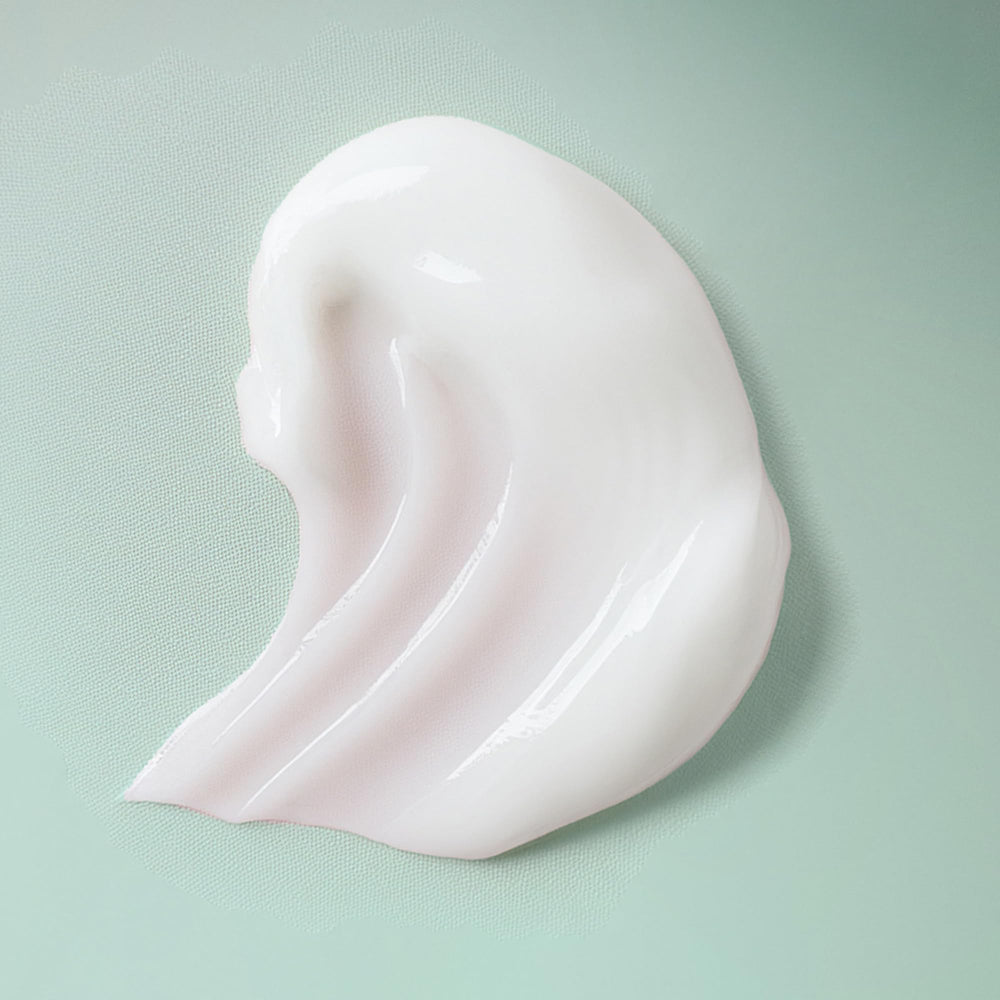 Ouidad VitalCurl+ Define & Shine bottle label detail emphasizes botanical omega complex.