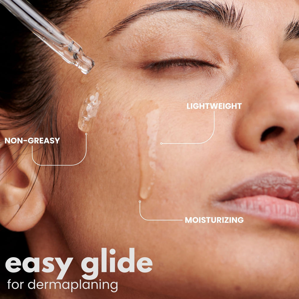Ouiloe Dermaplane Oil flatlay shows lightweight fragrance-free formula in use