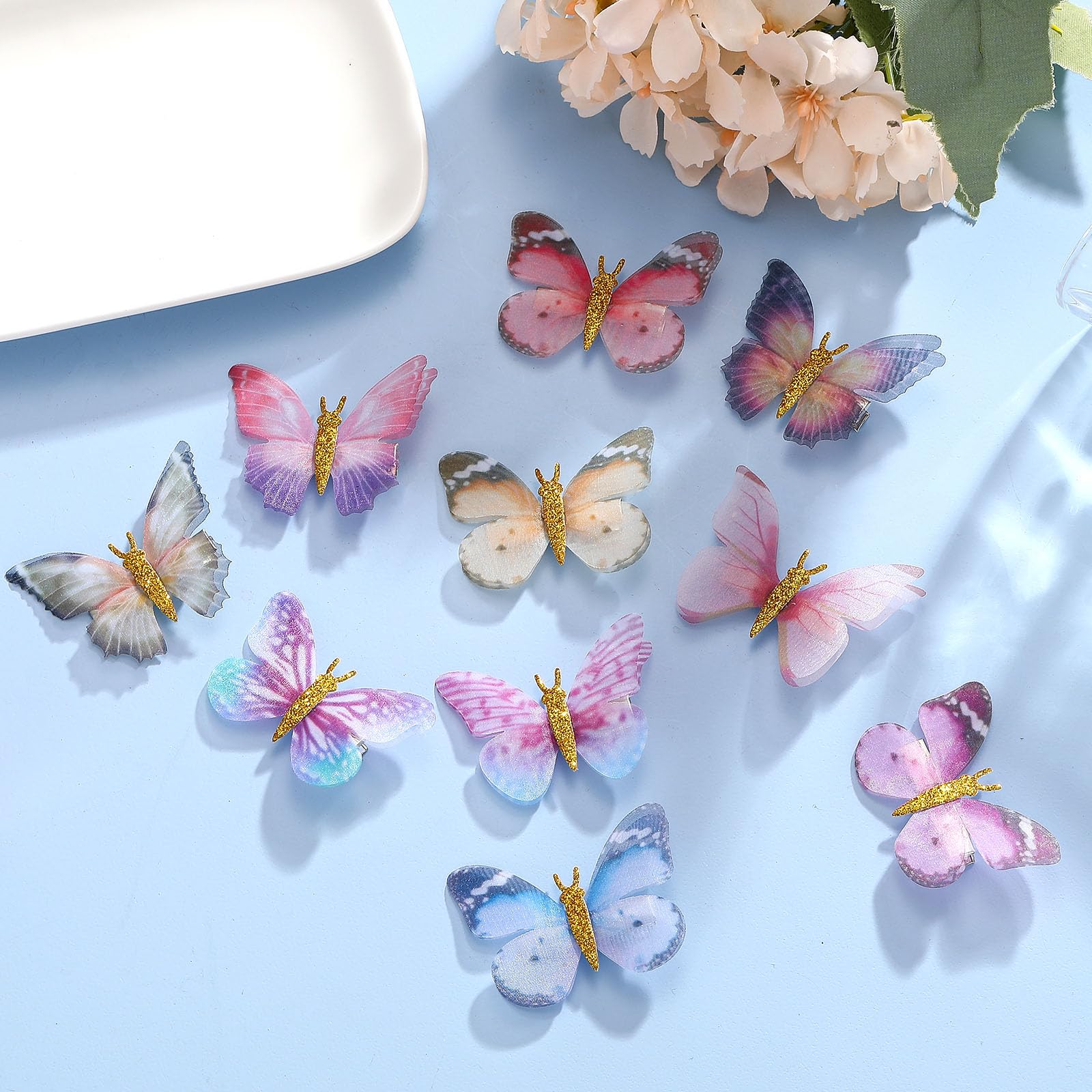 Paderison gold glitter body detail on butterfly clip catches light.