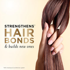 Pantene Miracle Rescue Shot ampoule being applied to mid-lengths for repair.