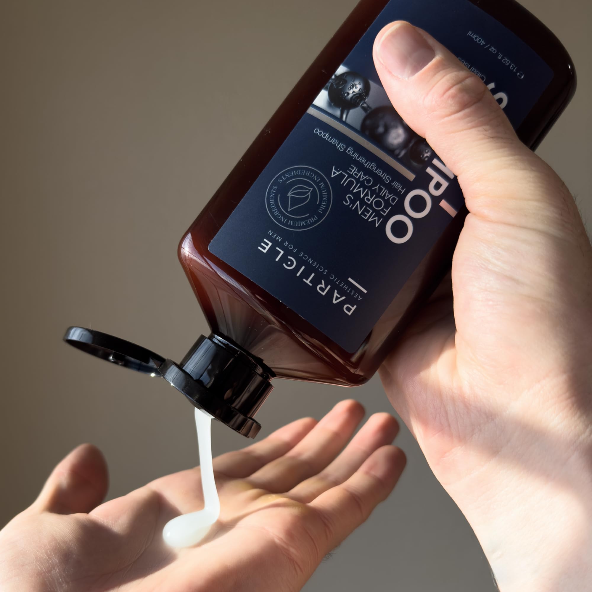 Closeup of biotin, Capixyl and Redensyl blend in Particle shampoo formula.