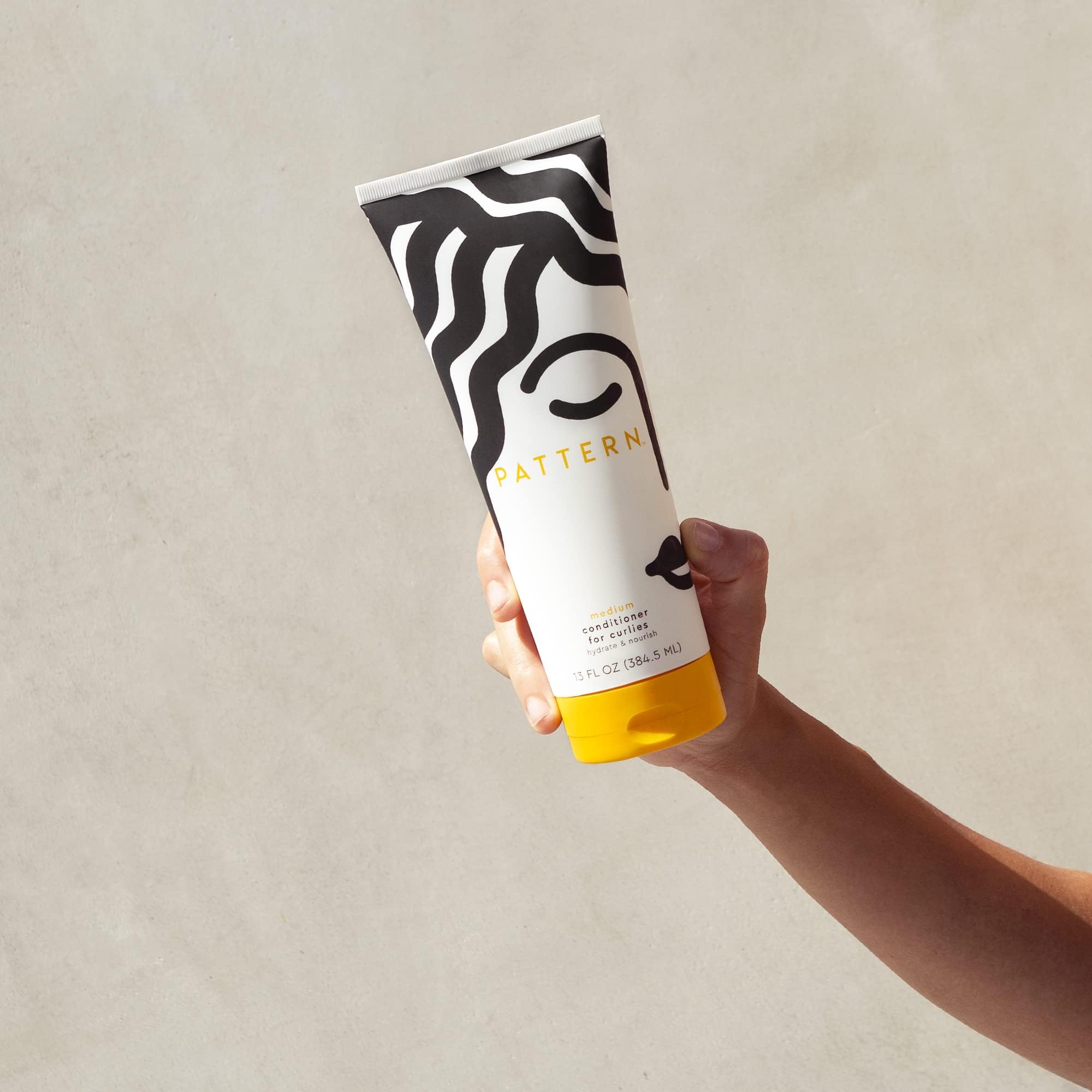 PATTERN conditioner cream texture ready for even distribution through curls.