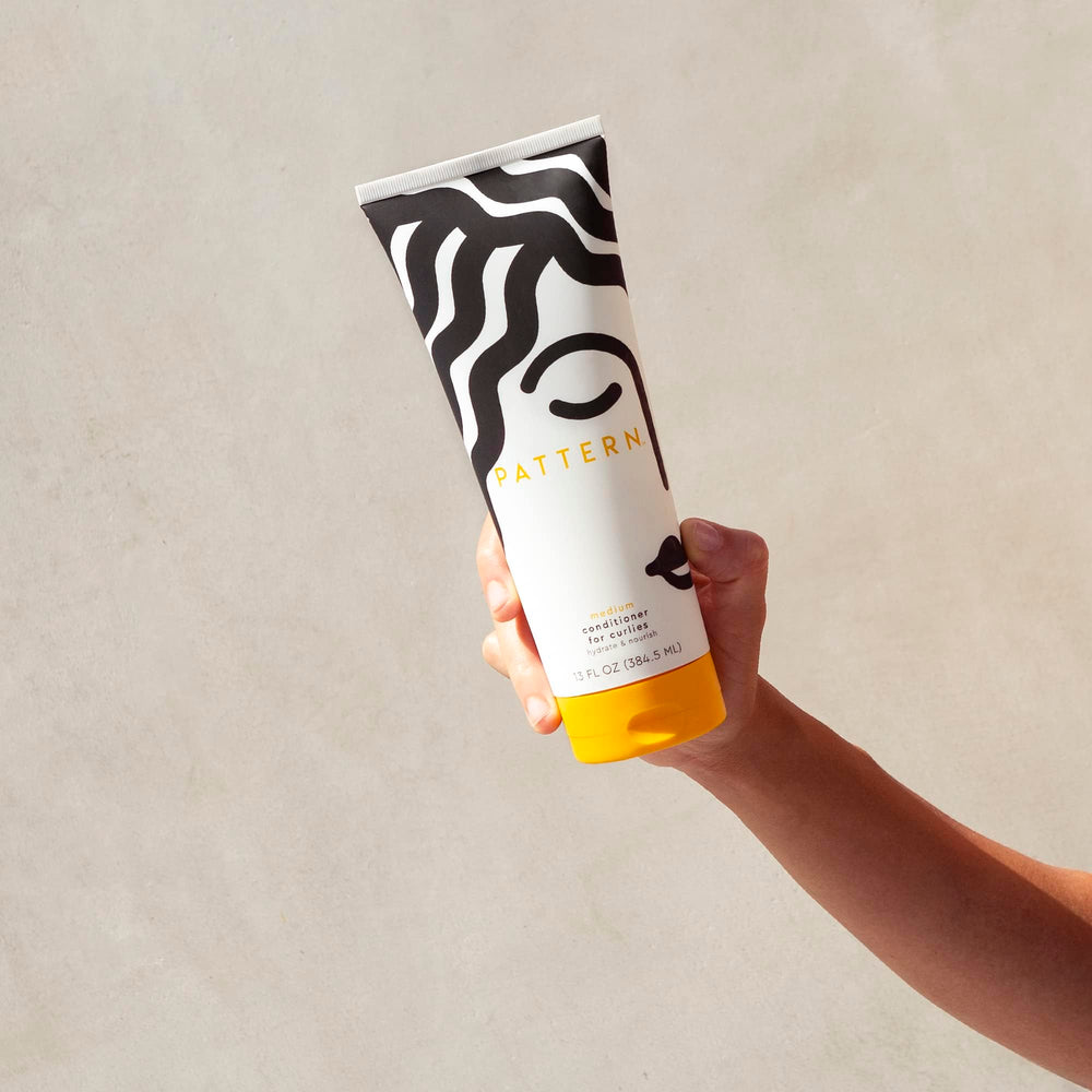 PATTERN conditioner cream texture ready for even distribution through curls.
