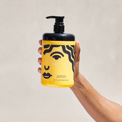 Detangling with PATTERN Leave-In Conditioner during hair care routine.