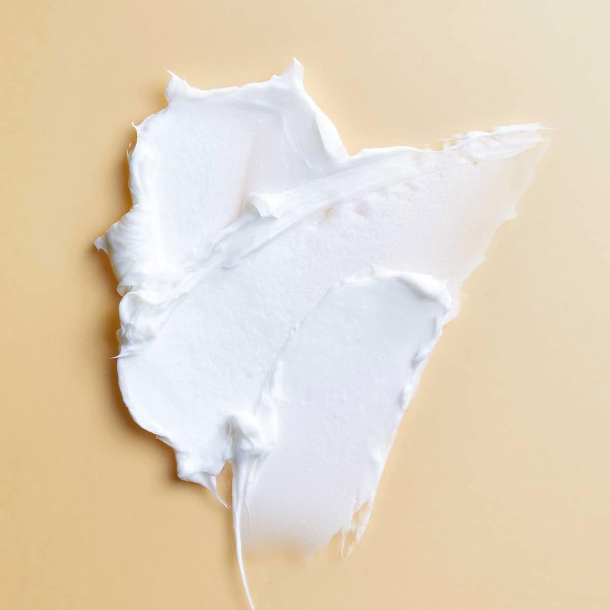 PATTERN Styling Cream texture swirls on fingers for moisture and elongation.