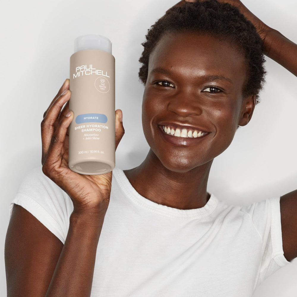 Pouring Paul Mitchell Sheer Hydration shampoo for easy cleansing