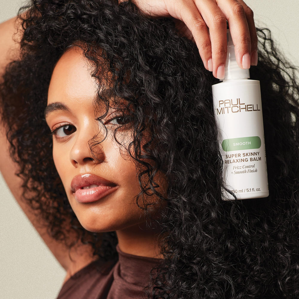 Paul Mitchell balm demonstrates humidity-resistant frizz protection for style.