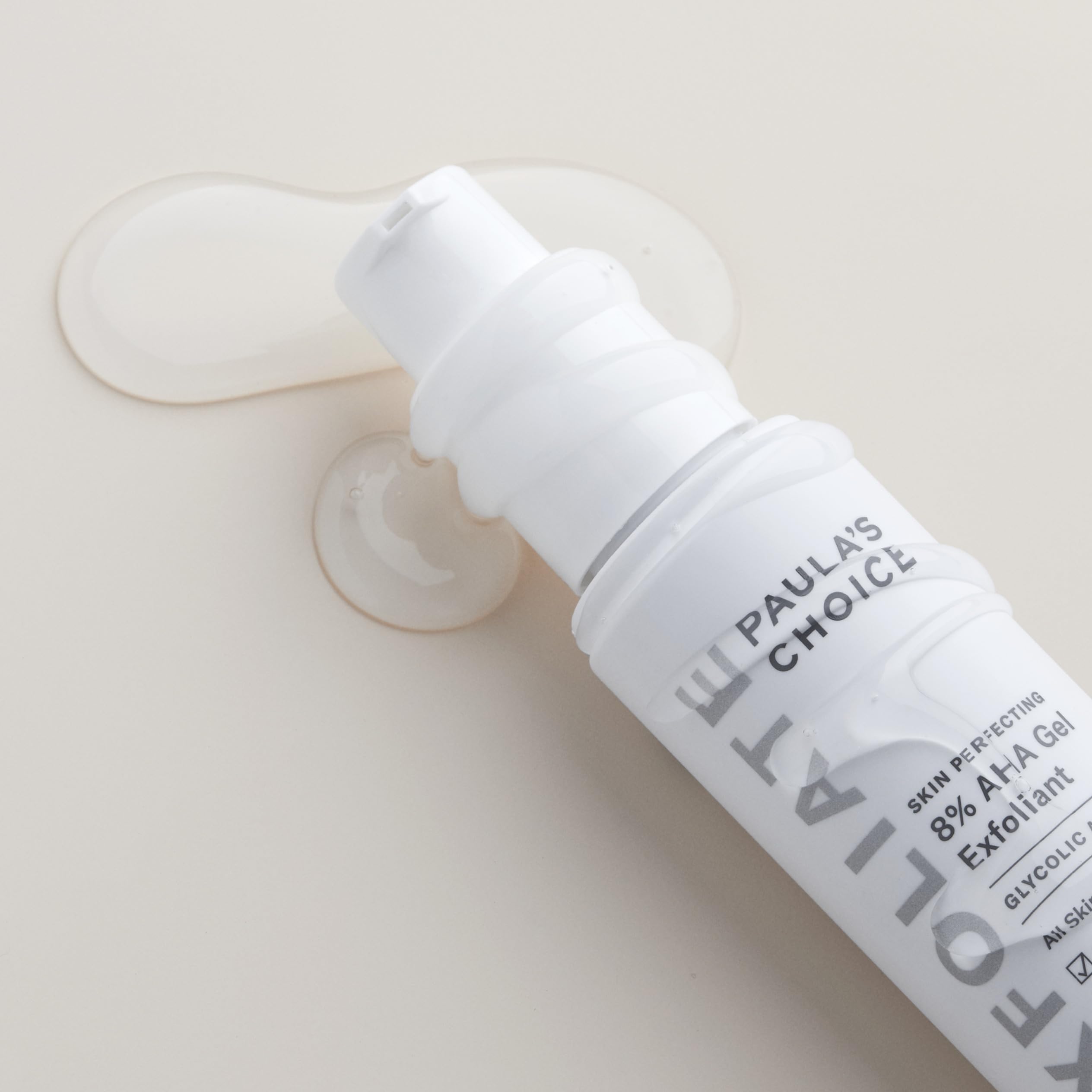 Paula's Choice gel exfoliant being applied on skin demonstrates non-abrasive use.