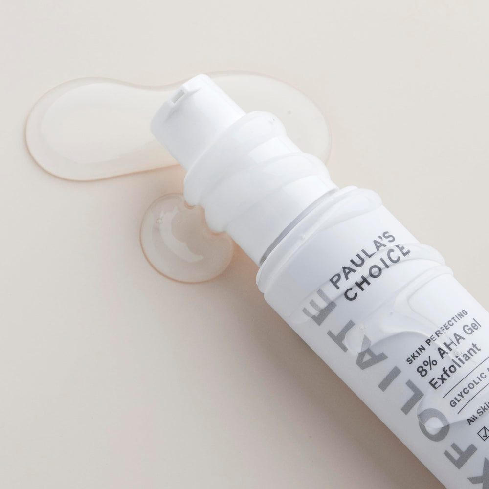 Paula's Choice gel exfoliant being applied on skin demonstrates non-abrasive use.