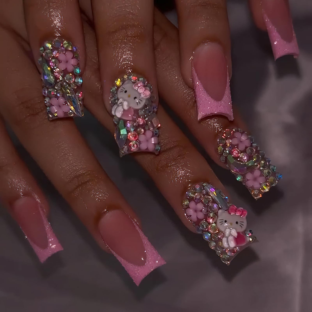 PDFADSK pink glitter French tip nails with rhinestones deliver a glossy, chic manicure.