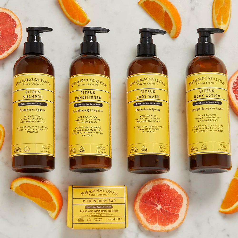 Pharmacopia Citrus Shampoo rinse scene with water droplets suggesting easy rinse