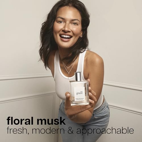 Philosophy Pure Grace spray mist captured mid-application for instant lift.