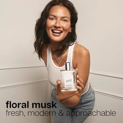 Philosophy Pure Grace spray mist captured mid-application for instant lift.