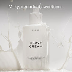 PHLUR Heavy Cream bottle being sprayed, illustrating hair and body use.