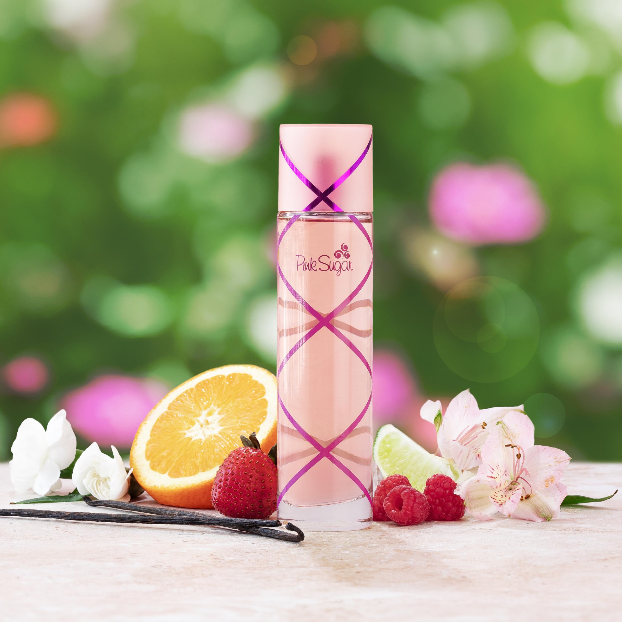 Pink Sugar bottle close-up highlights gourmand notes and branding.