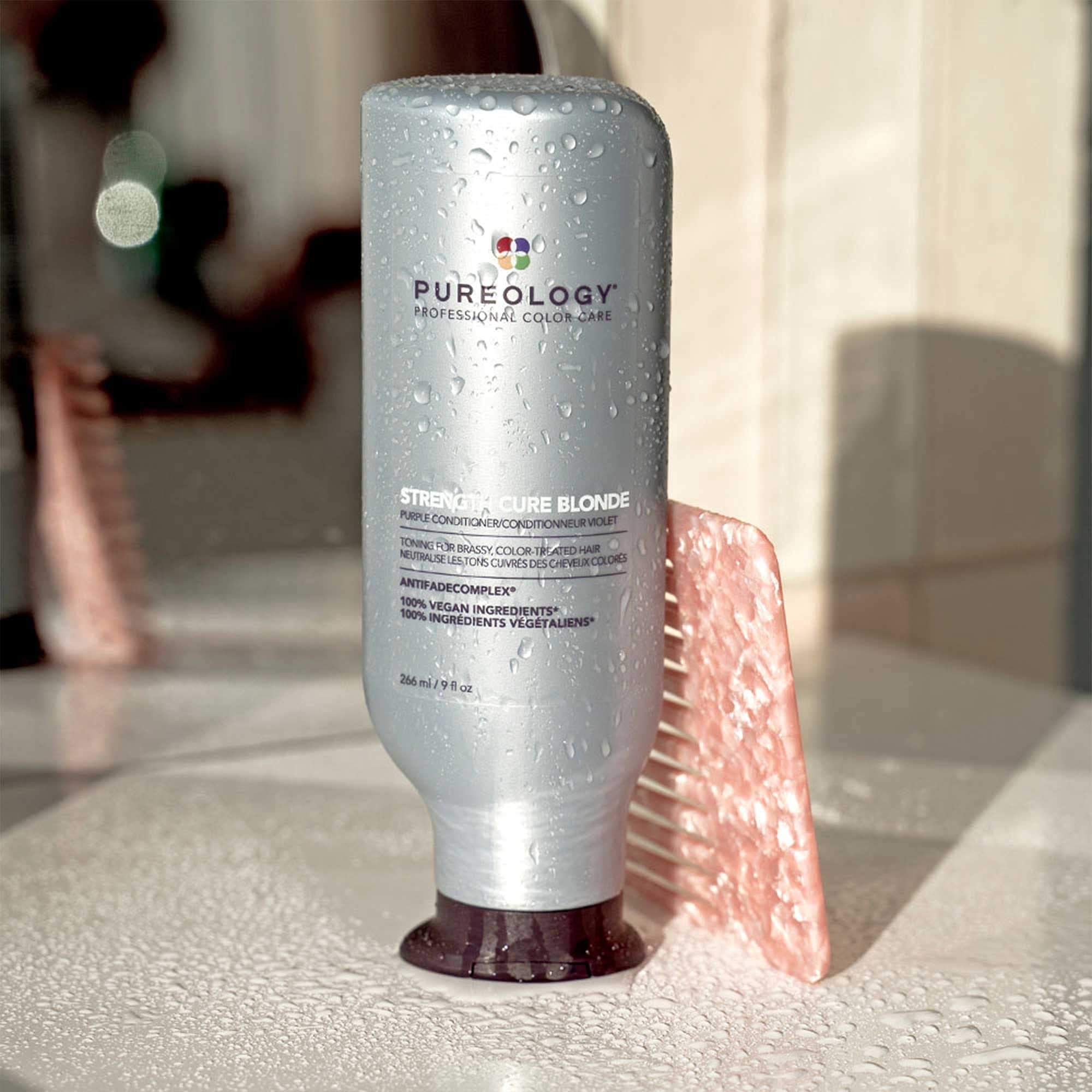 Color chart beside Pureology bottle illustrating blonde shade range.