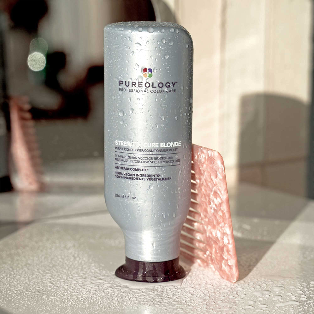 Color chart beside Pureology bottle illustrating blonde shade range.
