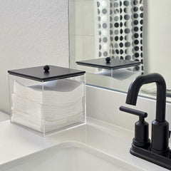 Puricon clear acrylic bin for facial towels with black lid enhances countertop organization.