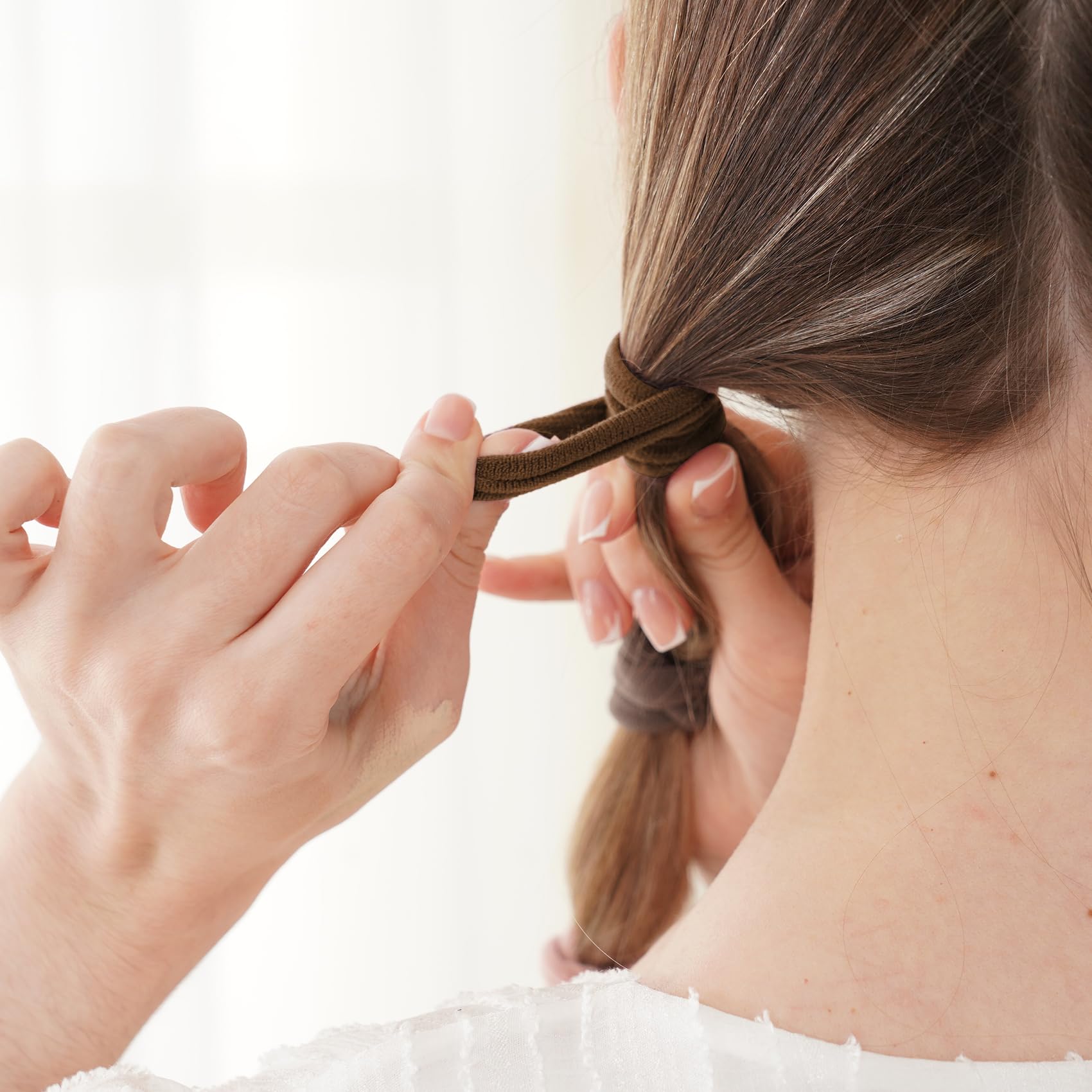 Qarwayoc no-damage cotton hair ties for easy removal and comfort.