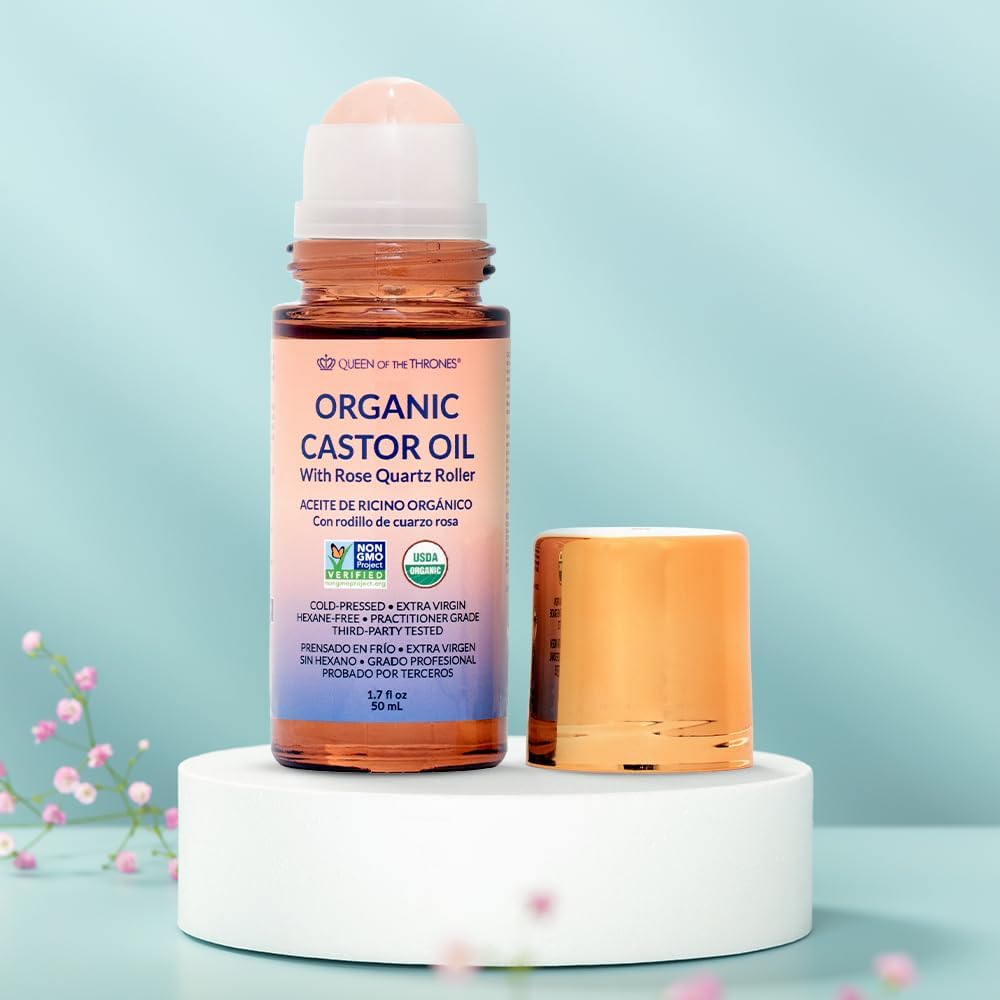 Queen of the Thrones Organic Golden Castor Oil glass bottle close-up highlighting purity and hexane-free formula.