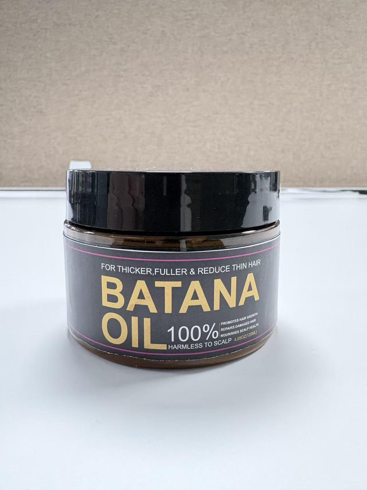 Qytin Batana Oil packaging close-up with eco-friendly design