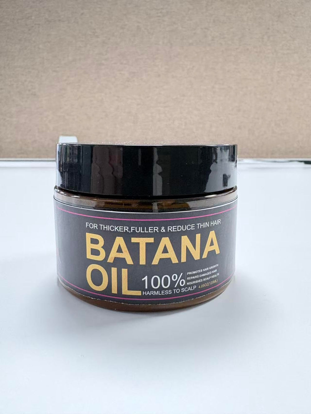 Qytin Batana Oil packaging close-up with eco-friendly design