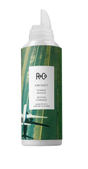 R+Co Aircraft Pomade Mousse bottle close-up showing lightweight texture and added body