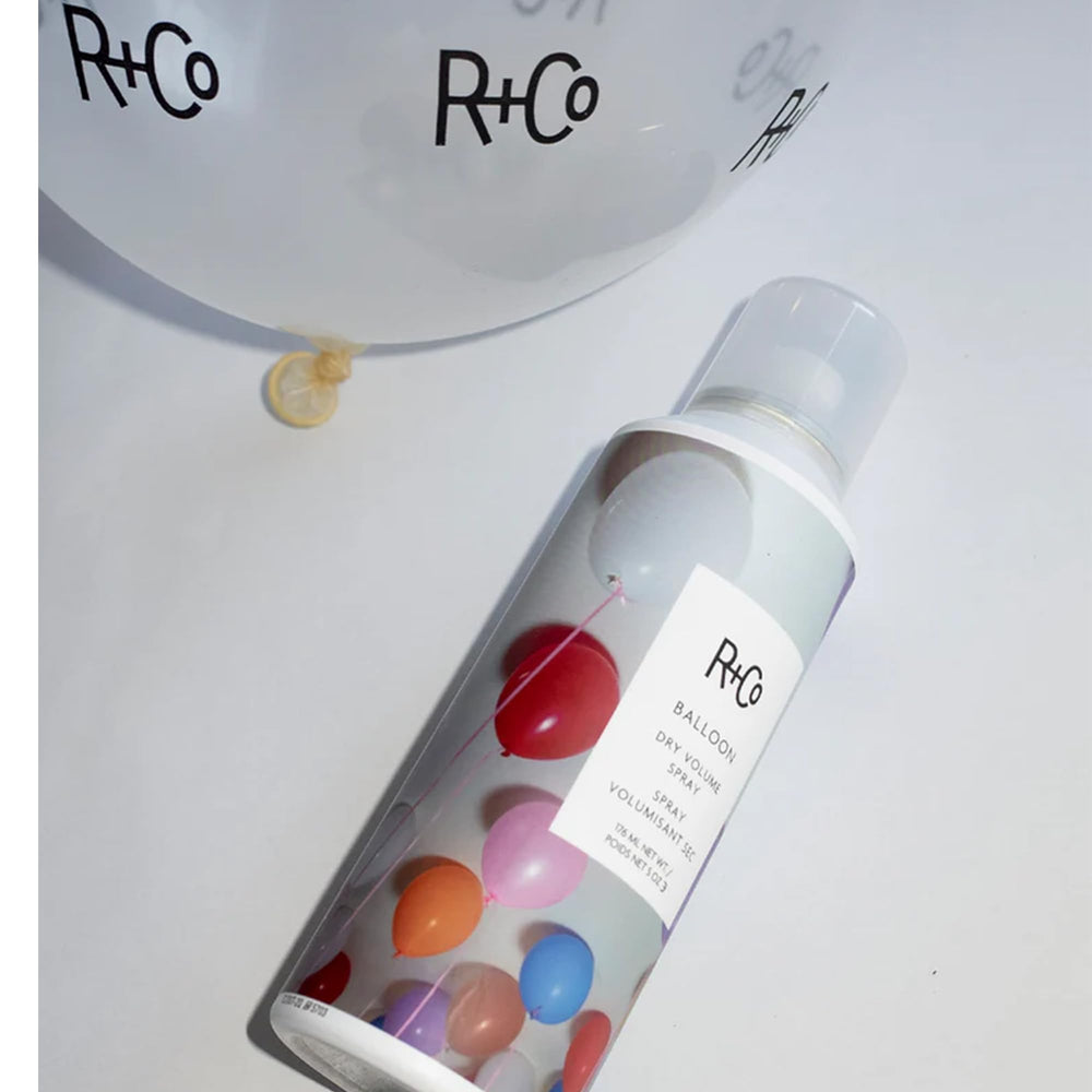 R+Co BALLOON hands applying lift for voluminous, movement-friendly hair
