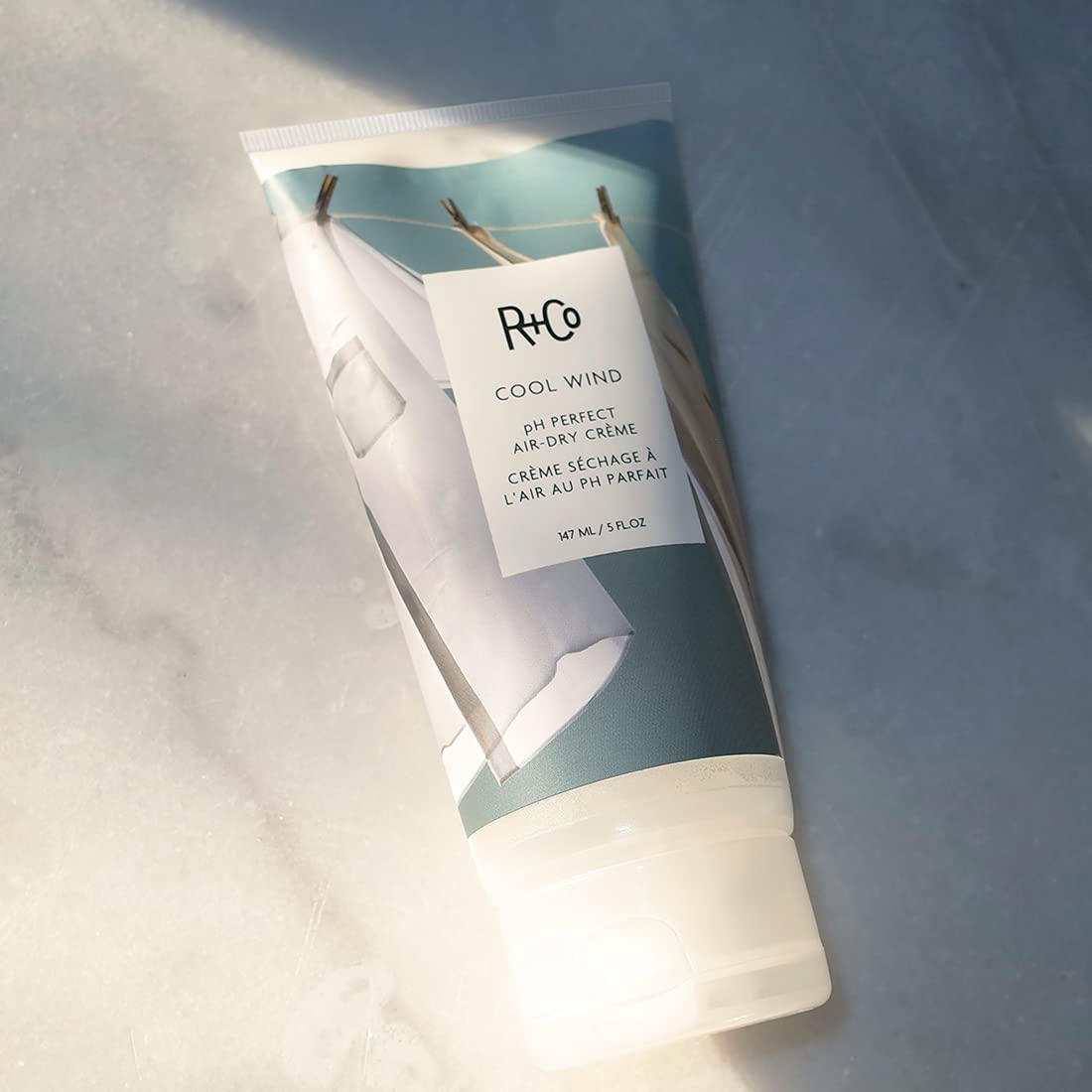 R+Co Cool Wind cream dispenser ready to use for effortless air-dry routine.