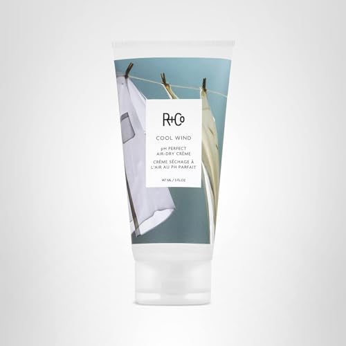 Applying R+Co Cool Wind on hair for controlled, air-dry styling.