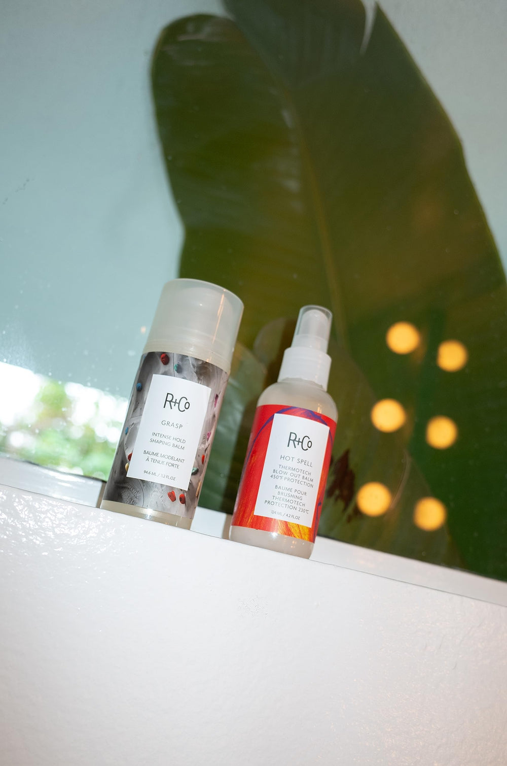 Close-up of R+Co balm enhancing shine and movement in hair
