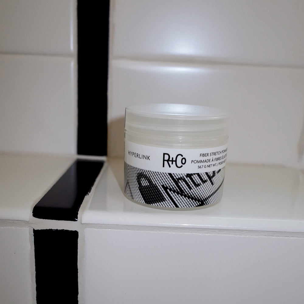 Frizz control demonstrated by Hyperlink Fiber Stretch Pomade on smooth strands.
