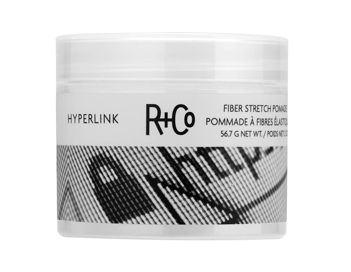R+Co Hyperlink Fiber Stretch Pomade bottle delivers weightless volume and flexible hold.