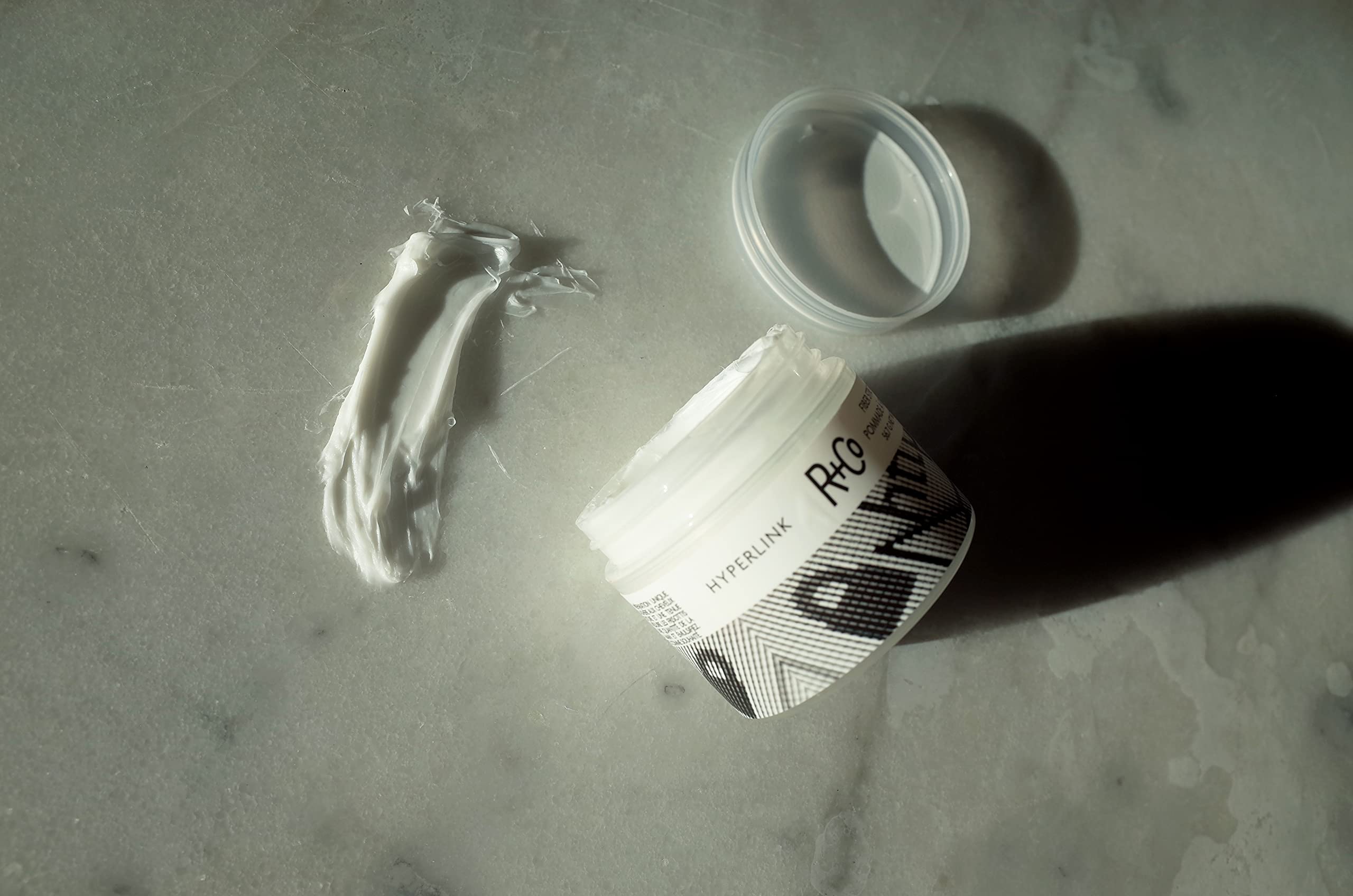 Damp hair styling with R+Co Hyperlink for lasting hold and movement.