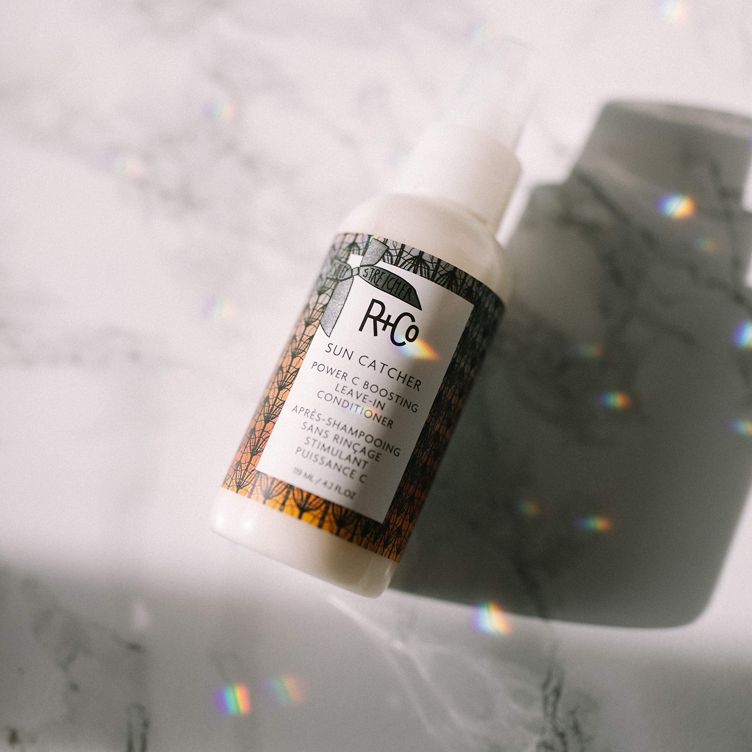 R+Co Sun Catcher Power C Leave-In bottle back with ingredients and usage notes