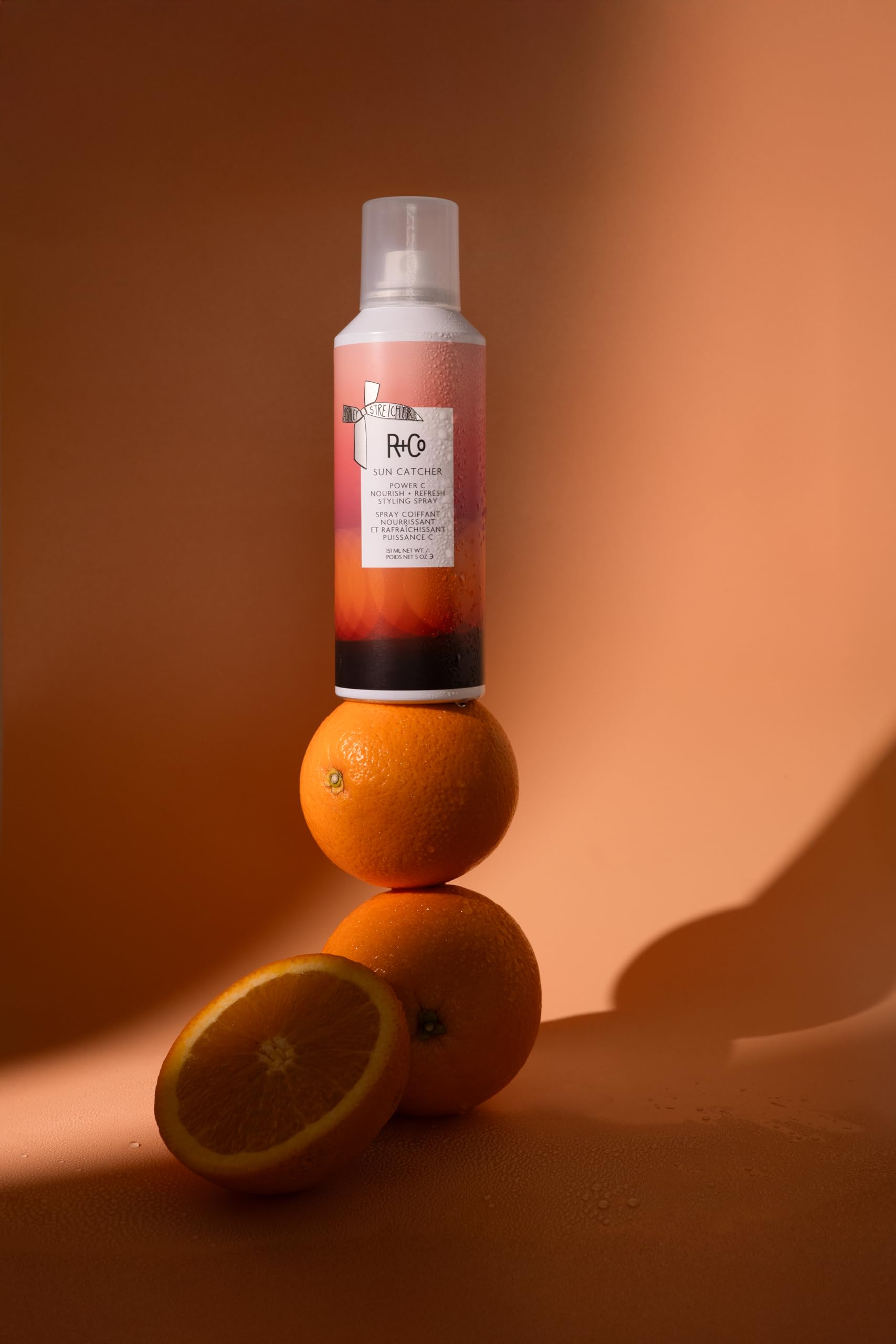 R+Co Sun Catcher mist being applied for quick refresh and hydration.