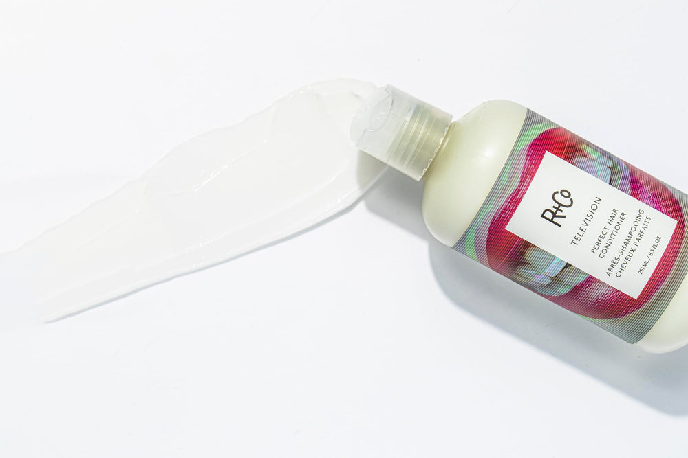 R+Co Television conditioner on sink demonstrates quick shine boost during daily routine.