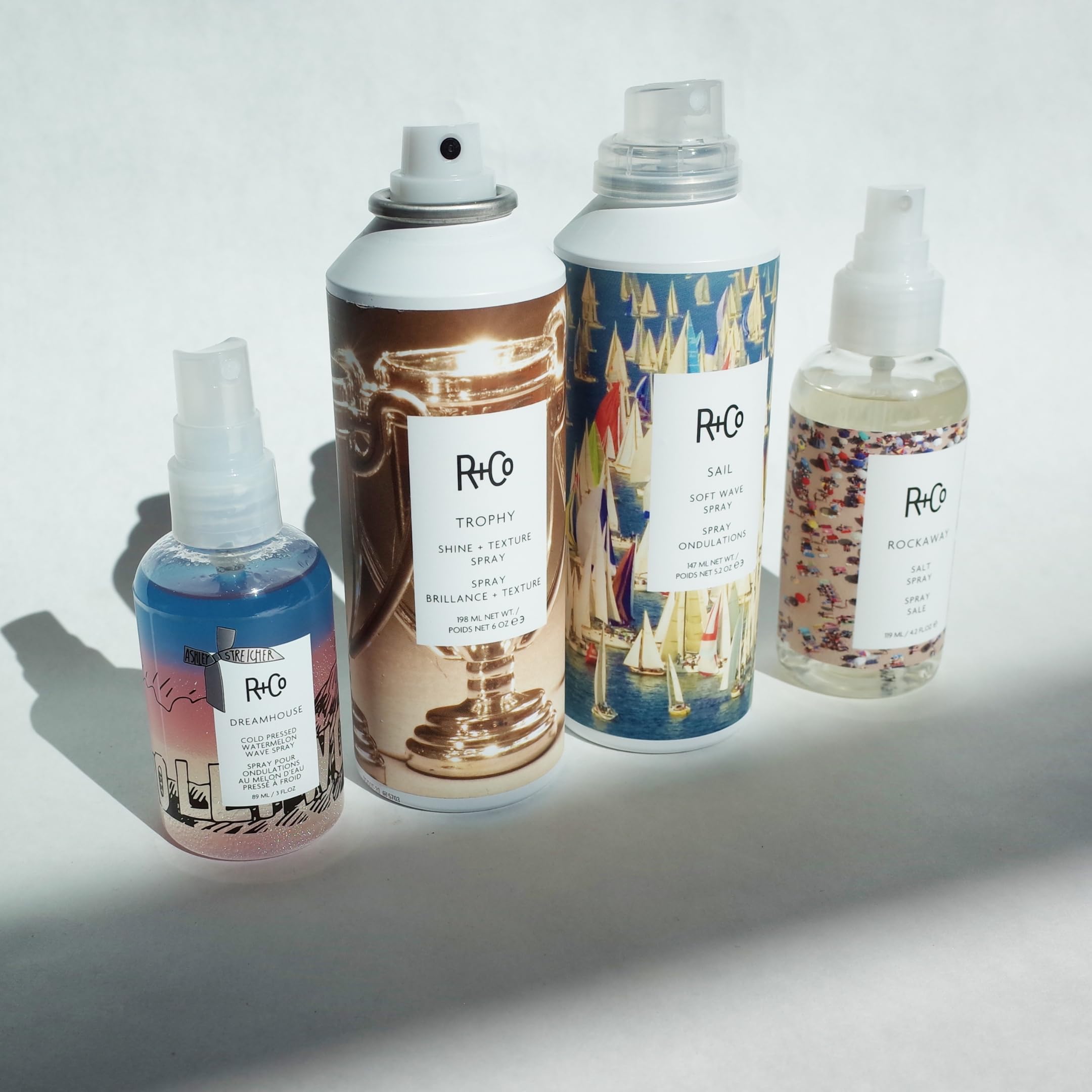 R+Co Trophy Shine + Texture Spray absorbs excess oil for a refreshed feel.