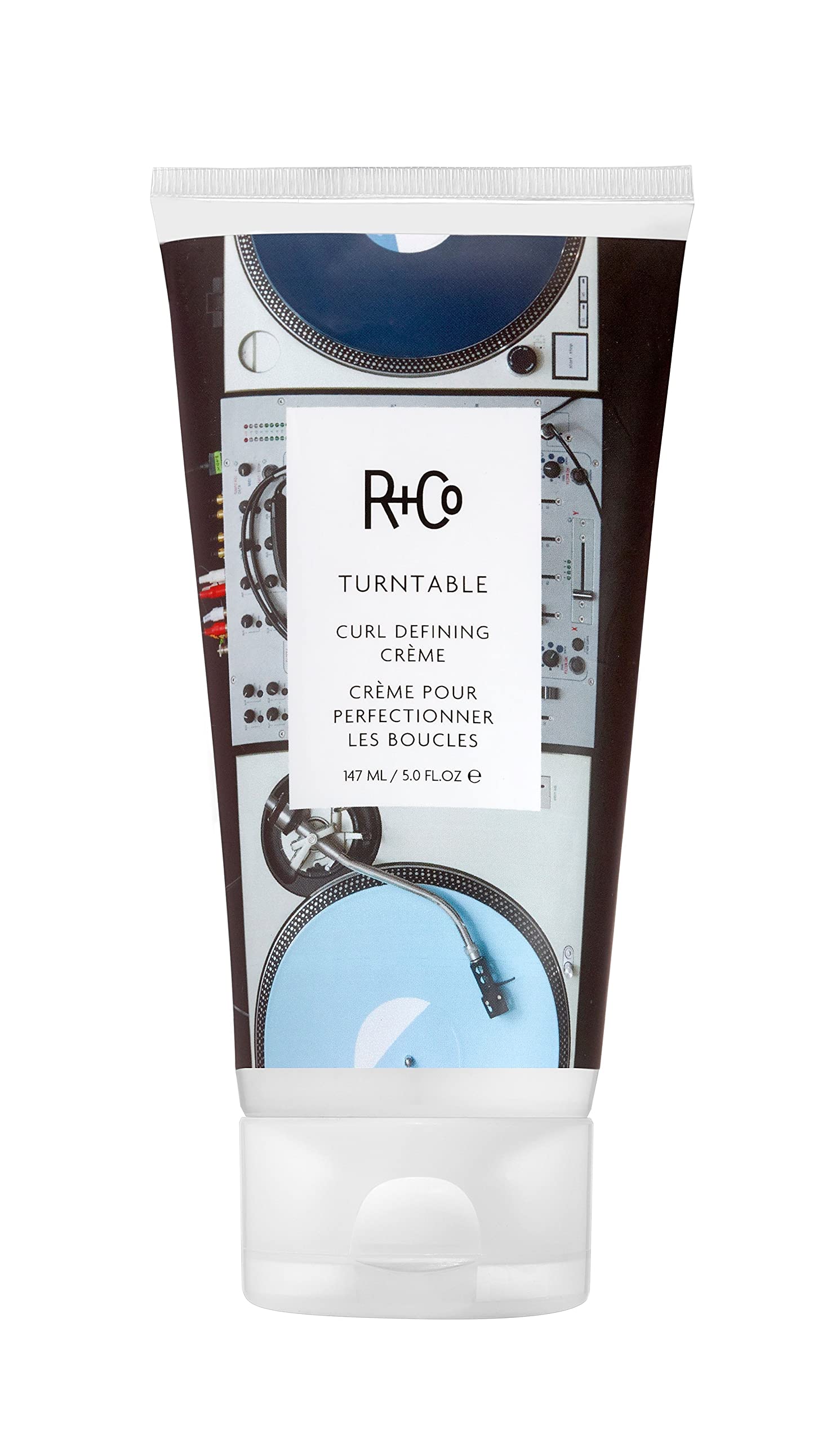 R+Co TURNTABLE bottle close-up showcasing lightweight curl-defining formula.