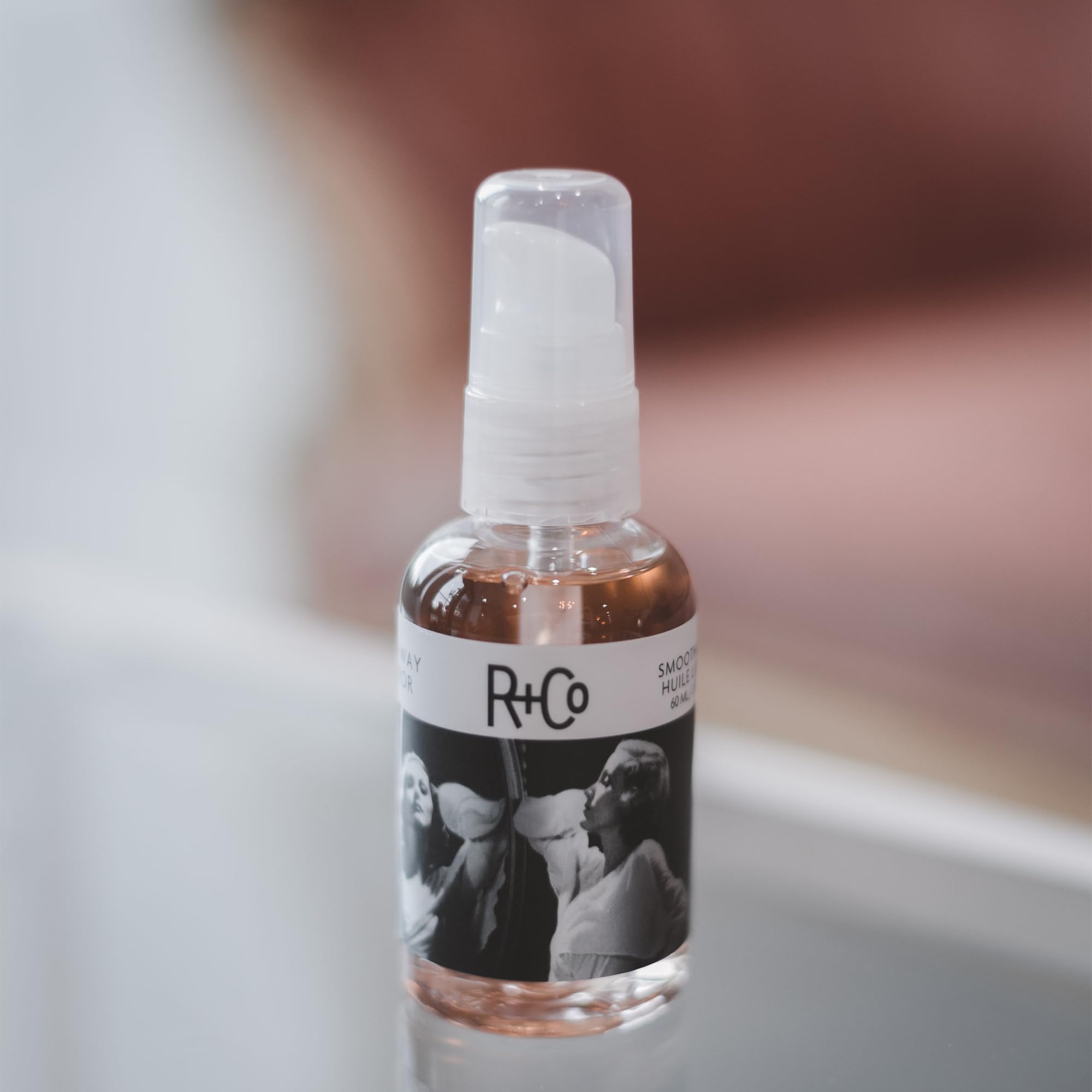 R+Co Two Way Mirror application close-up shows easy, weightless polish for hair.