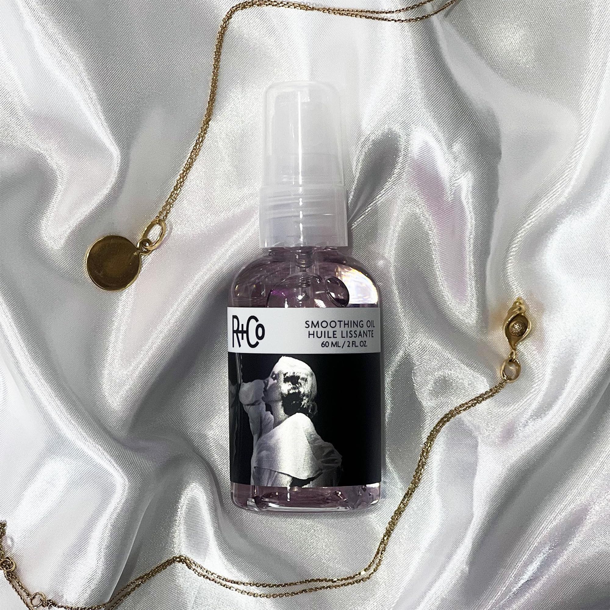 R+Co Two Way Mirror hair-gloss close-up emphasizes reflective shine and soft texture.