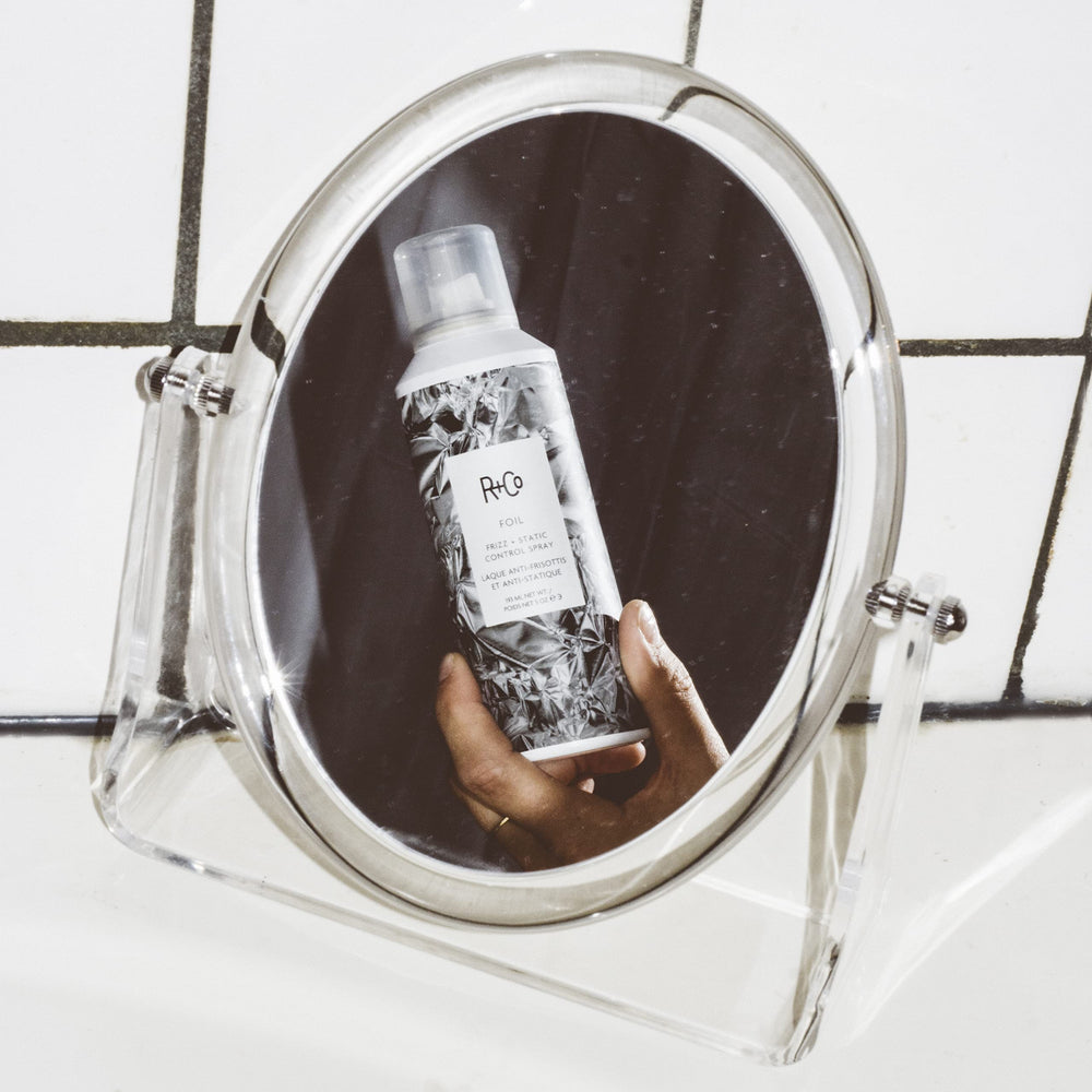 R+Co Foil Frizz + Static spray mist in air for flexible hold.
