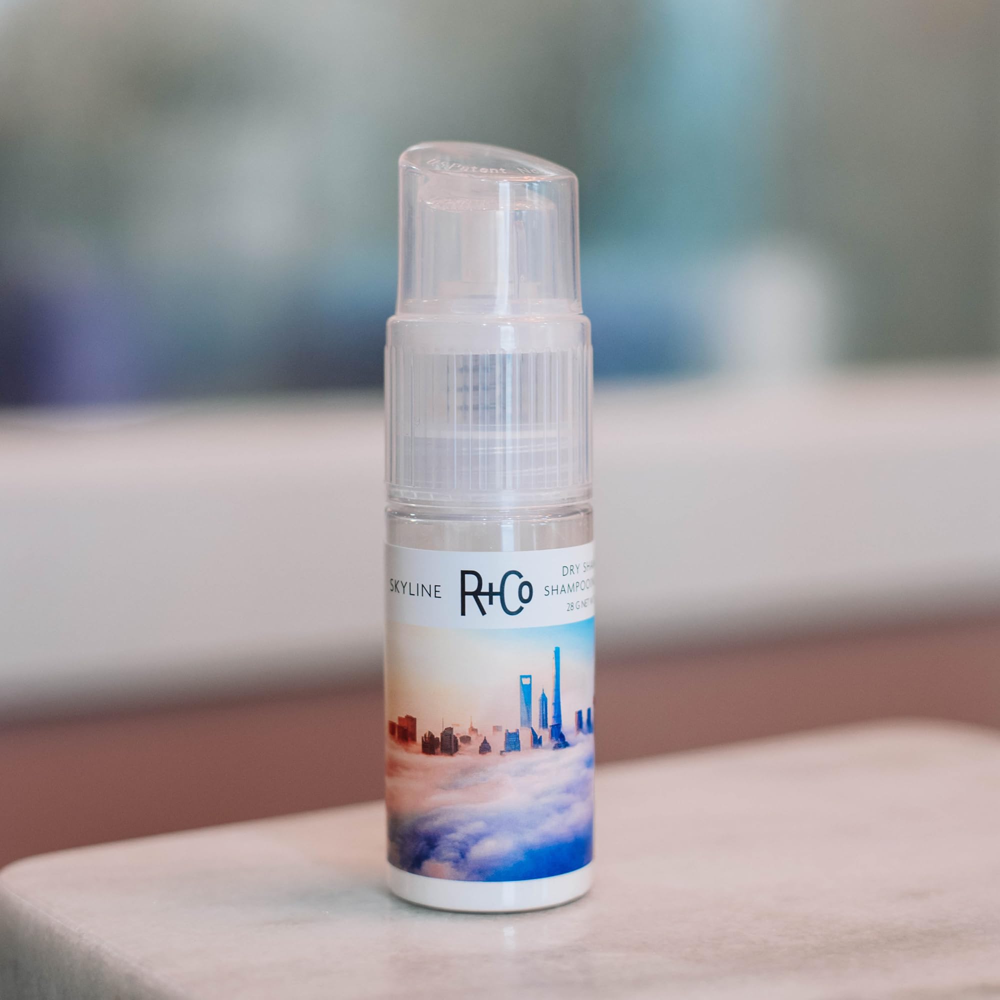 R+Co Skyline Dry Shampoo Powder includes jojoba seed oil for shine.