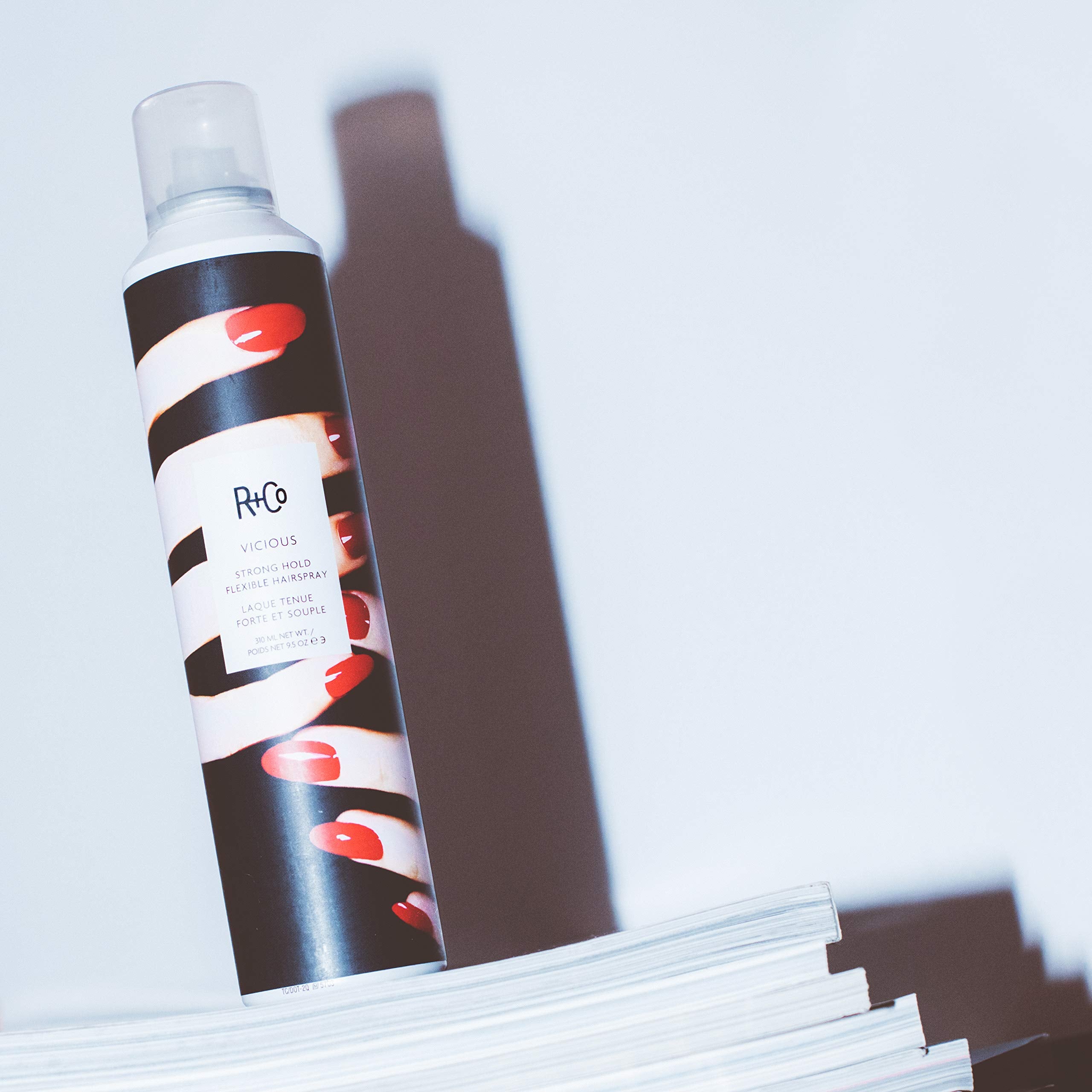 R+Co VICIOUS hairspray on bathroom vanity ready for styling touch-ups.