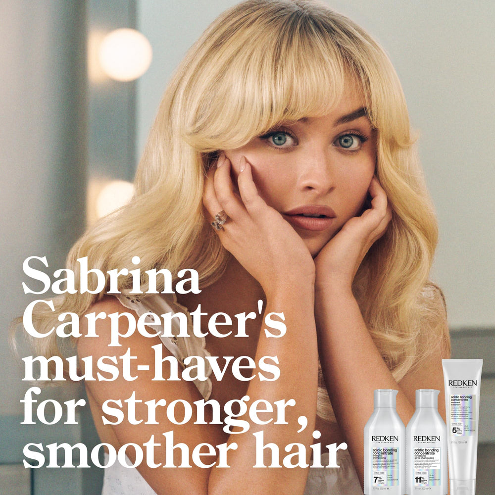 Redken mask on wet hair creating smooth, manageable coverage.