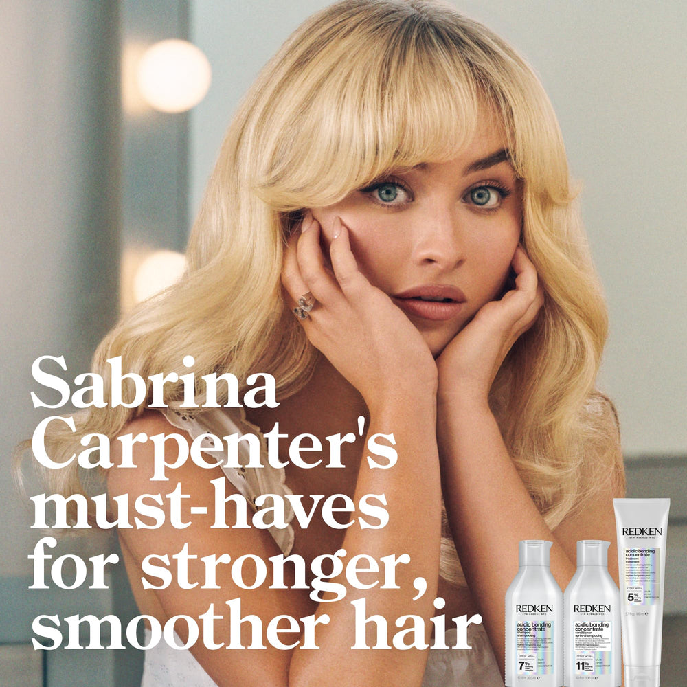 Redken conditioner being applied during routine care for color-treated hair