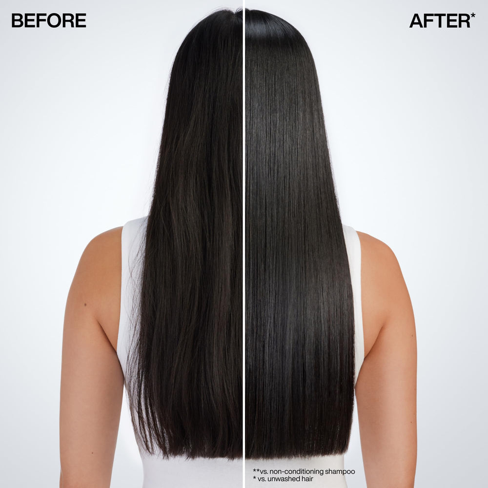 Redken Acidic Color Gloss mask being applied to damp strands.