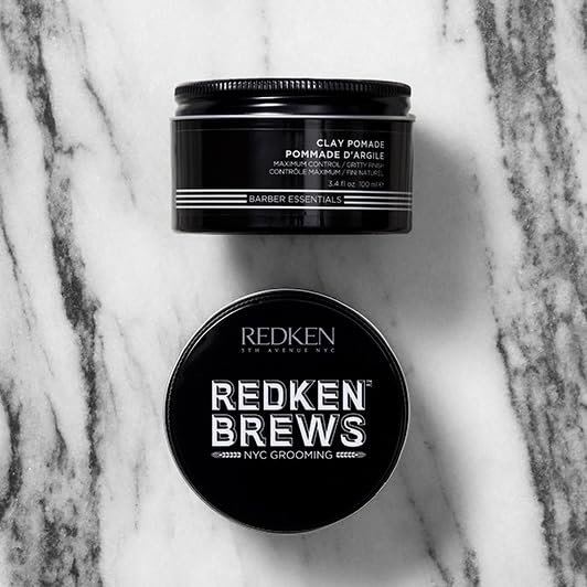 Model with Redken Brews Clay Pomade styled hair for strong hold