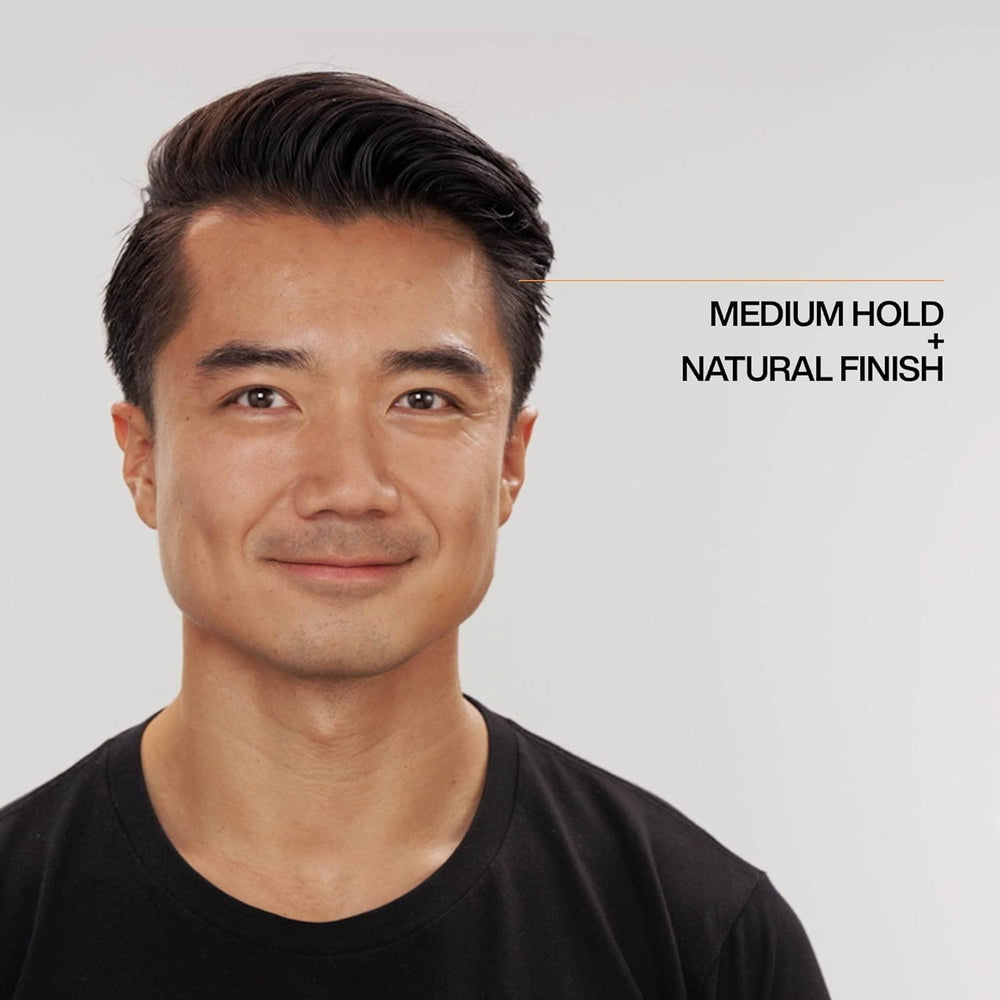 Redken Brews Cream Pomade texture on hair for defined, flexible style.